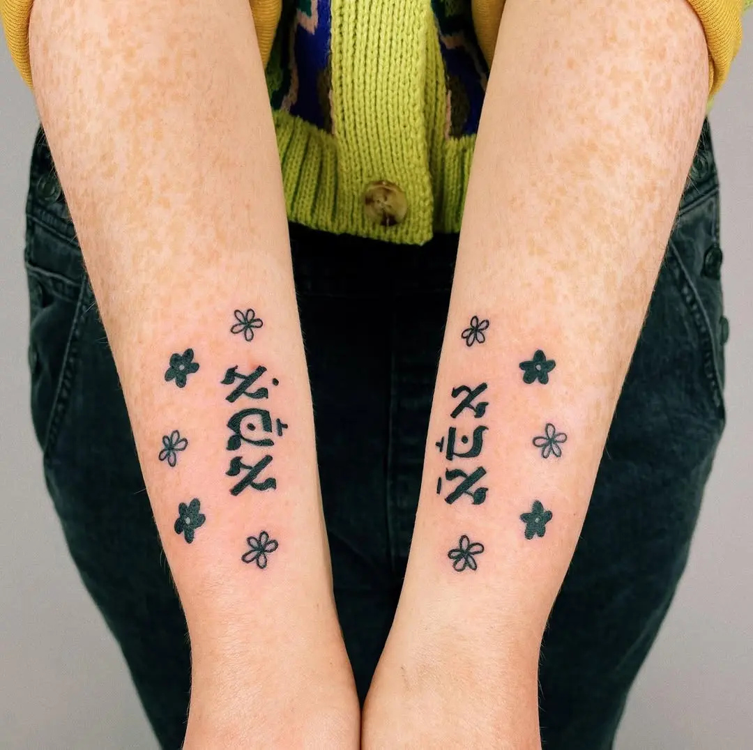 Delicate Hebrew Tattoos with Flower Accents