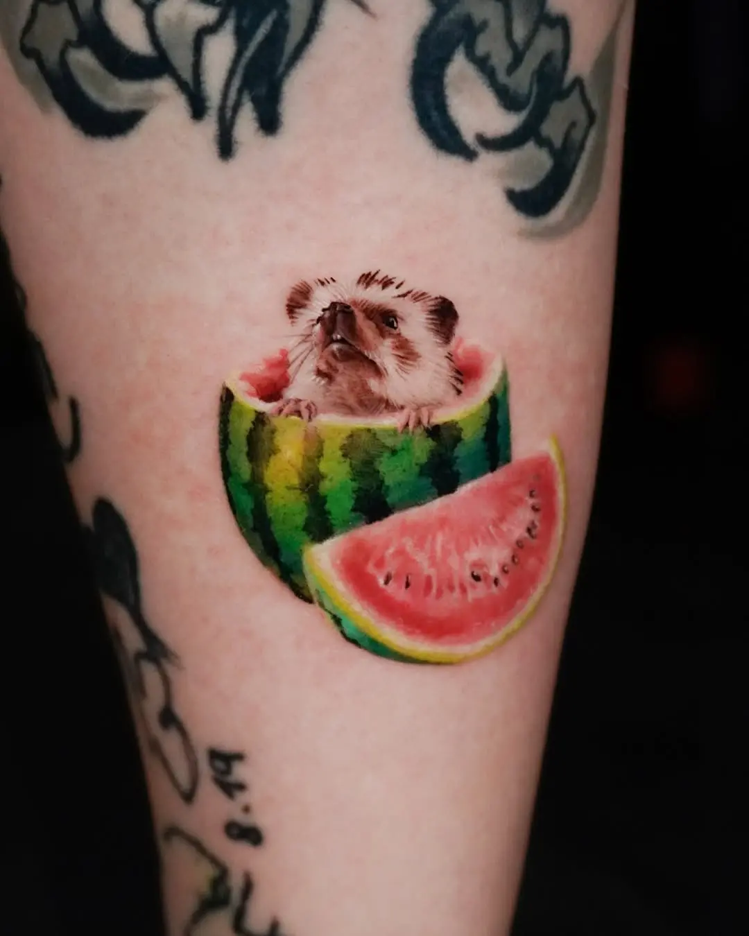 Whimsical hedgehog nestled in vibrant watermelon tattoo