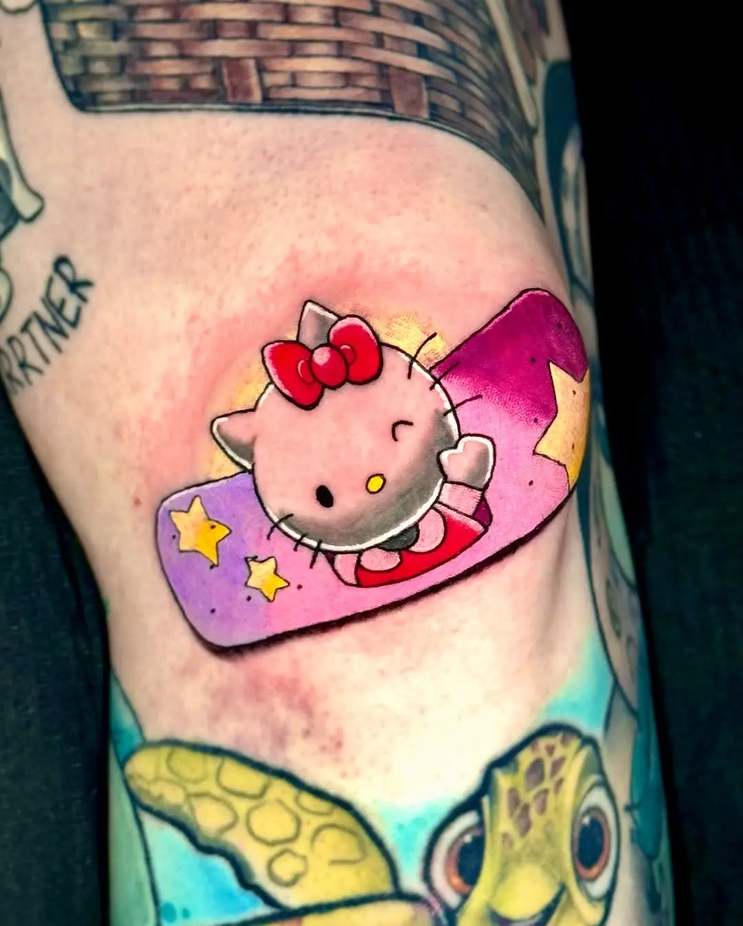 Cute Hello Kitty Tattoo with Colorful Bandage