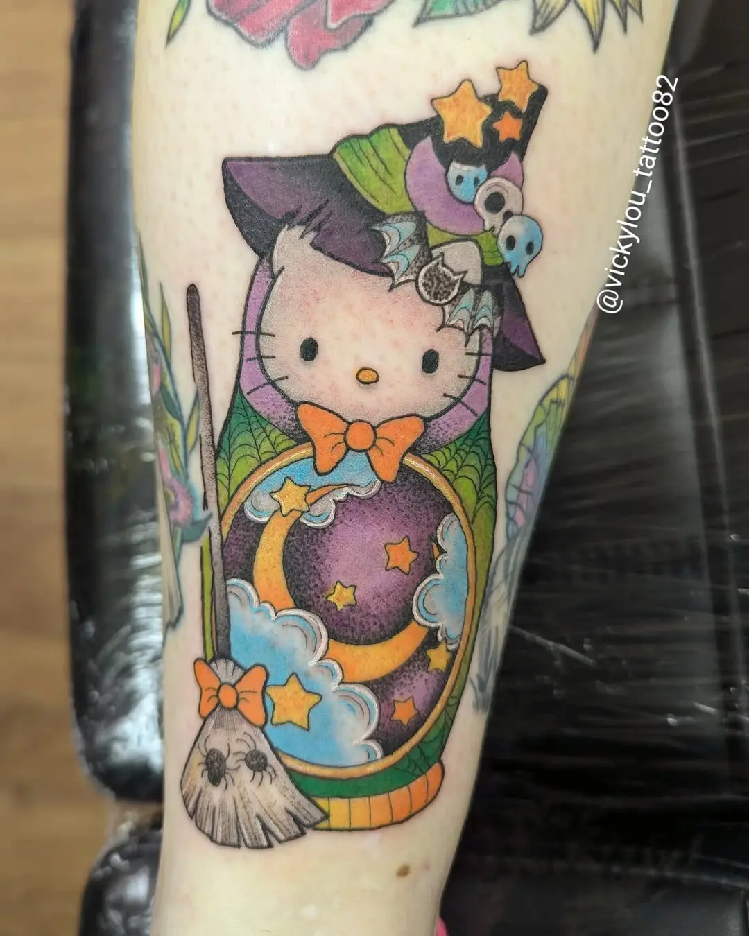 Charming witch-themed Hello Kitty tattoo design
