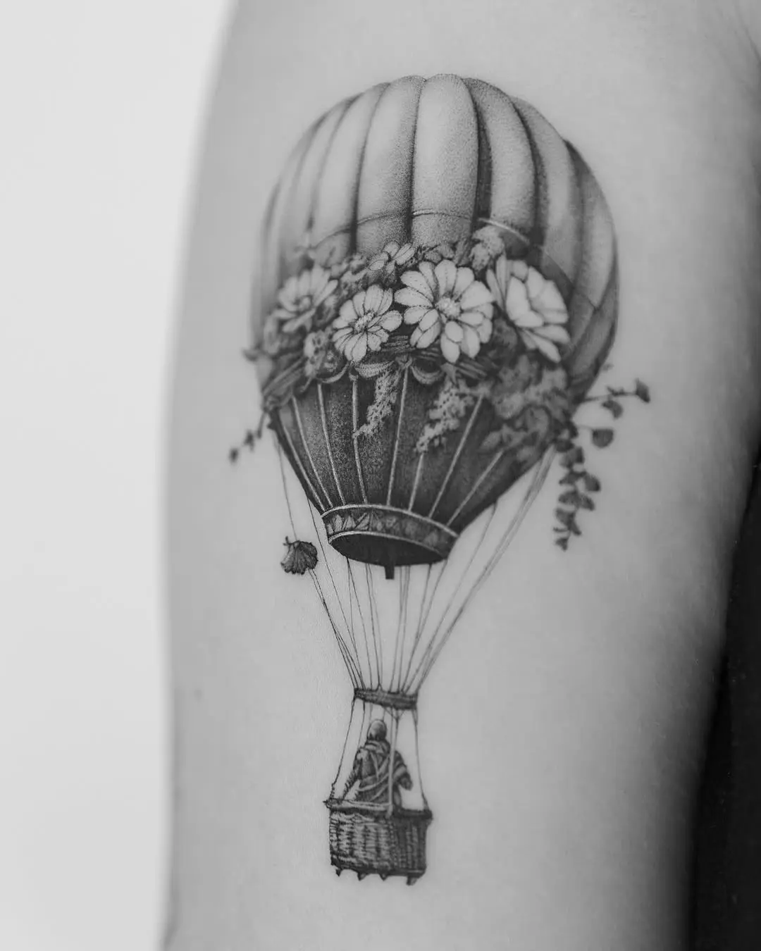 Charming floral hot air balloon tattoo design