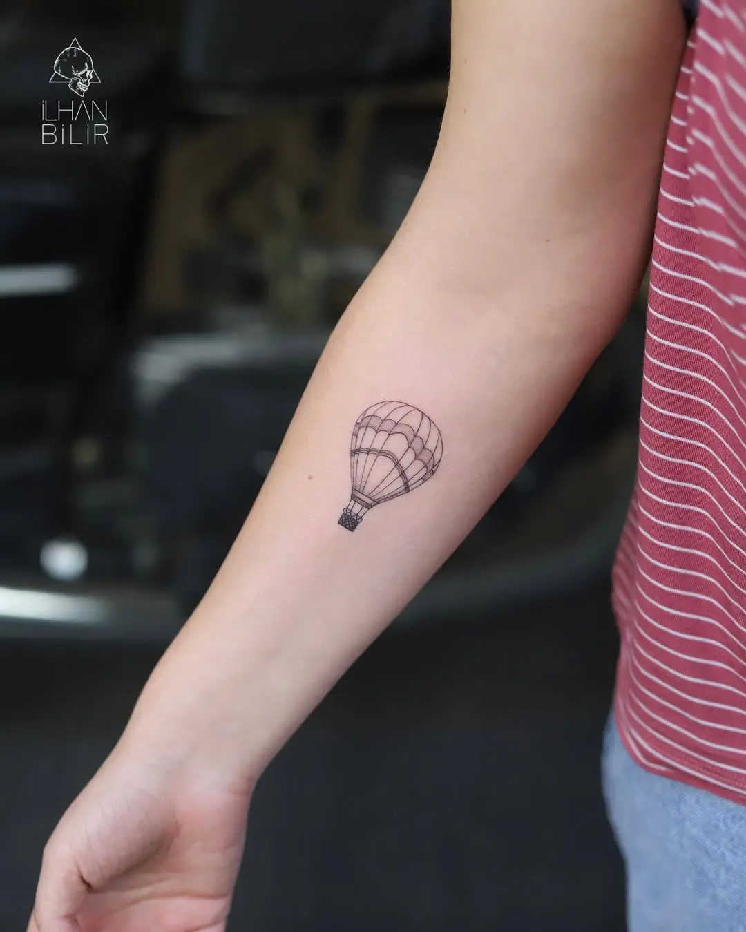 Simple hot air balloon tattoo on the forearm