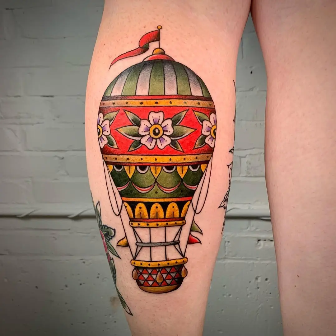 Colorful hot air balloon tattoo with floral patterns