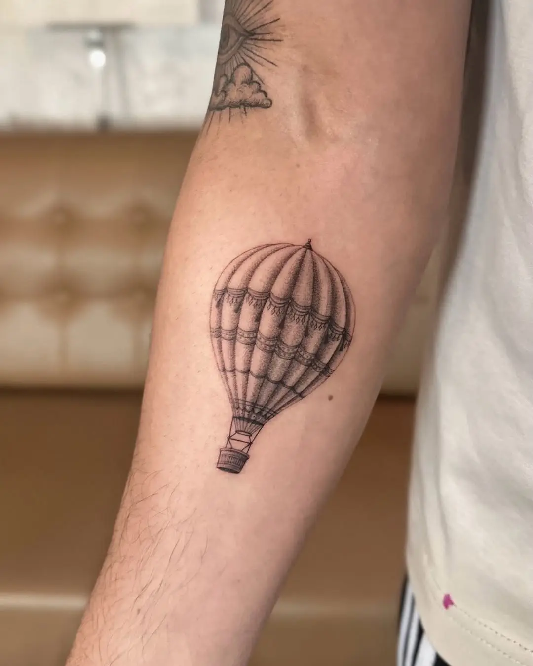 Elegant hot air balloon tattoo on forearm