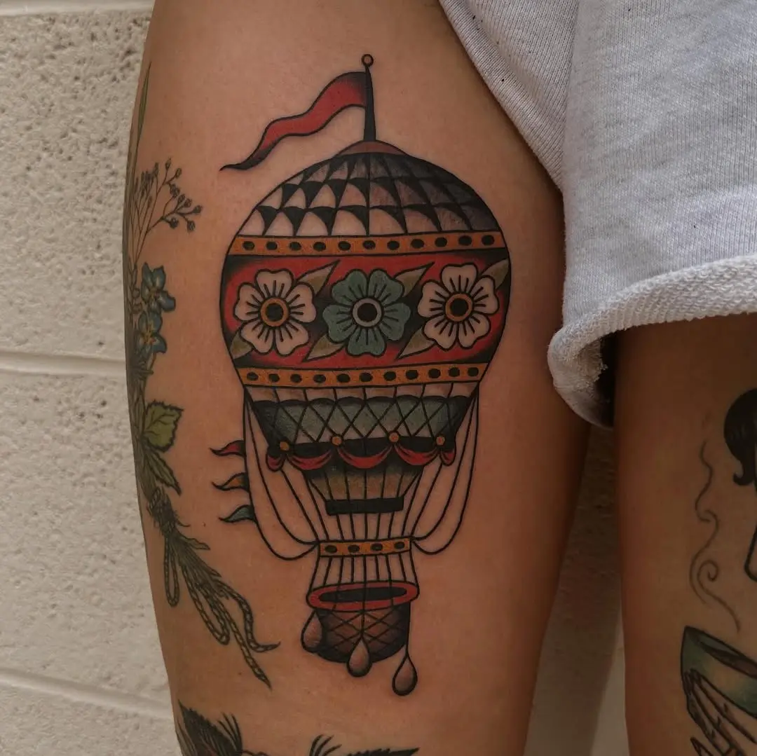 Colorful hot air balloon tattoo on thigh