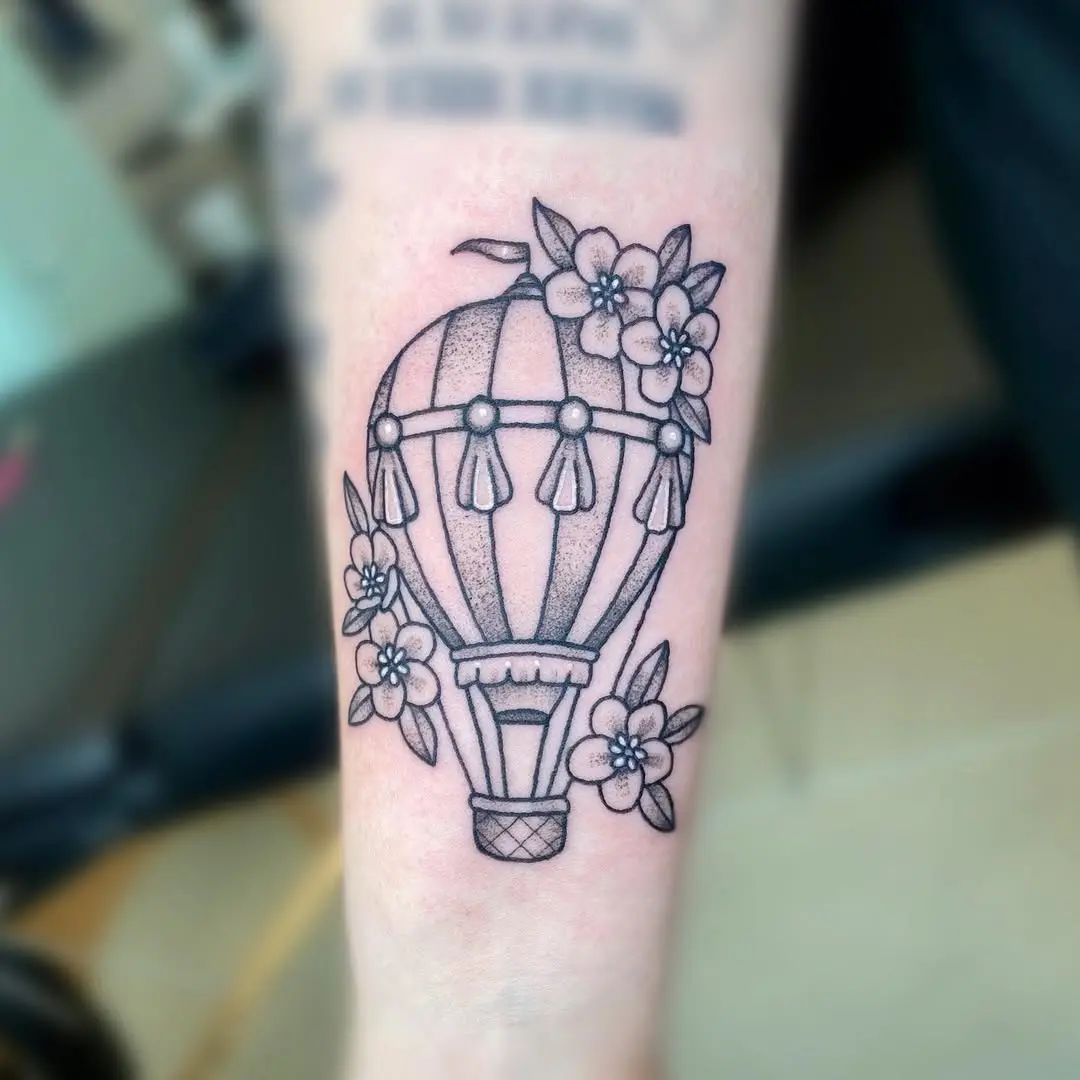 Elegant hot air balloon tattoo with floral accents