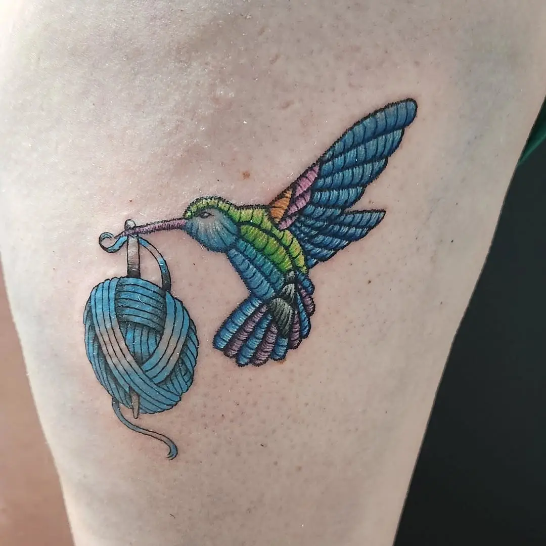 Colorful embroidery tattoo of a hummingbird