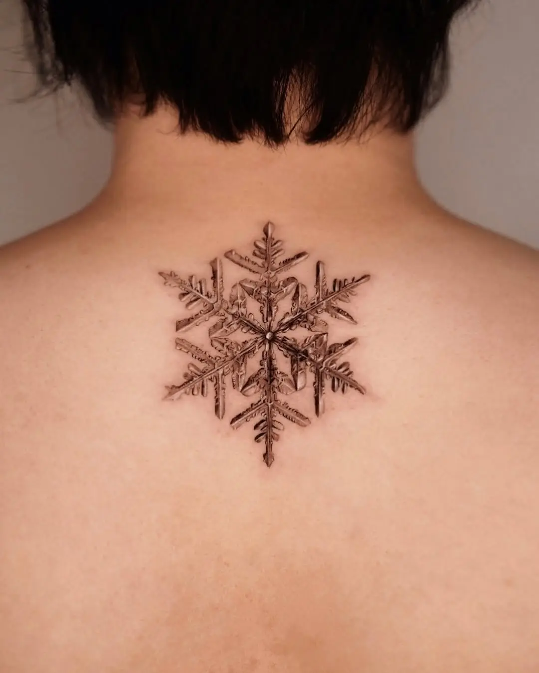 Stunning intricate snowflake tattoo design