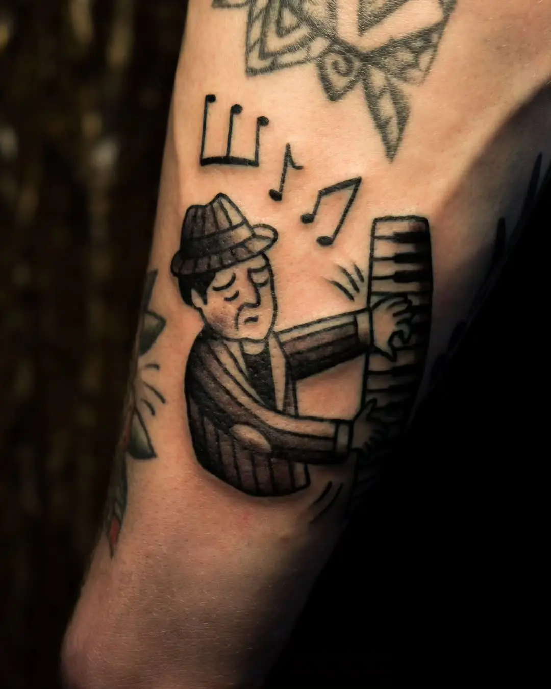 Stylish jazz musician playing the piano tattoo