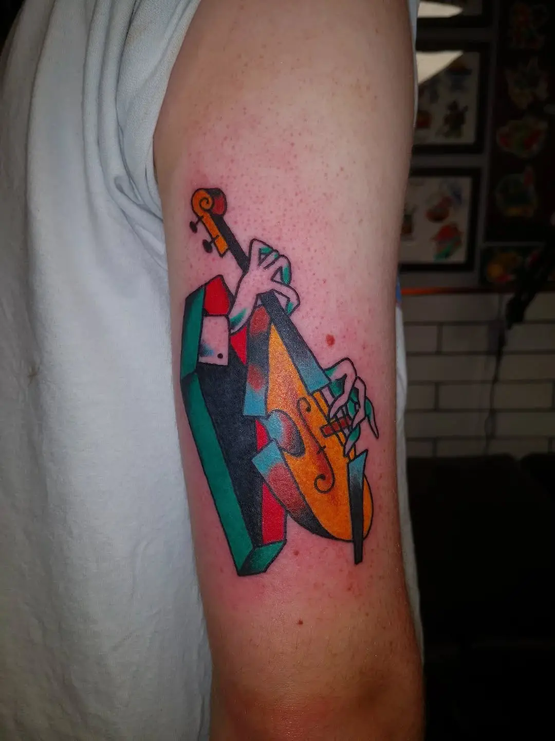 Vibrant jazz tattoo of a bassist