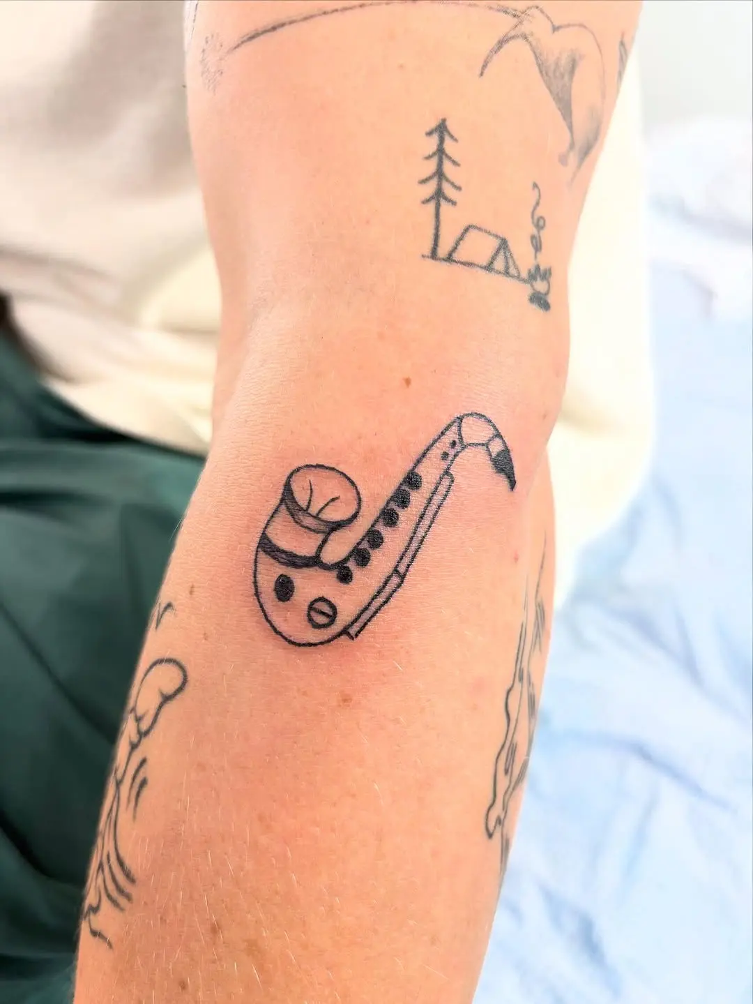 Unique saxophone tattoo with a minimalist design