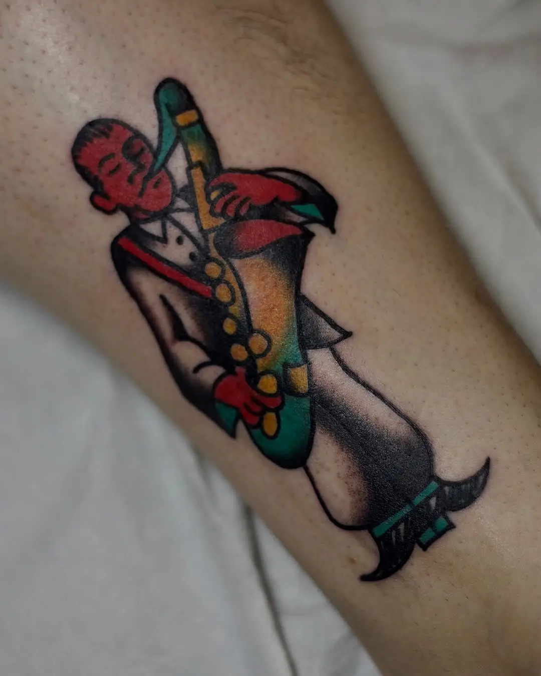 Colorful saxophonist tattoo celebrating jazz culture