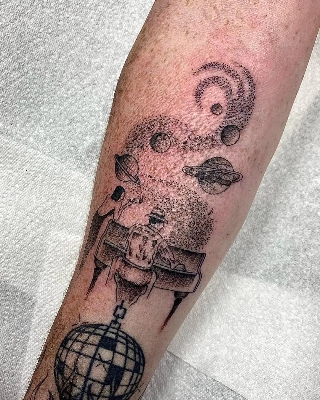 Cosmic jazz tattoo with musical elements