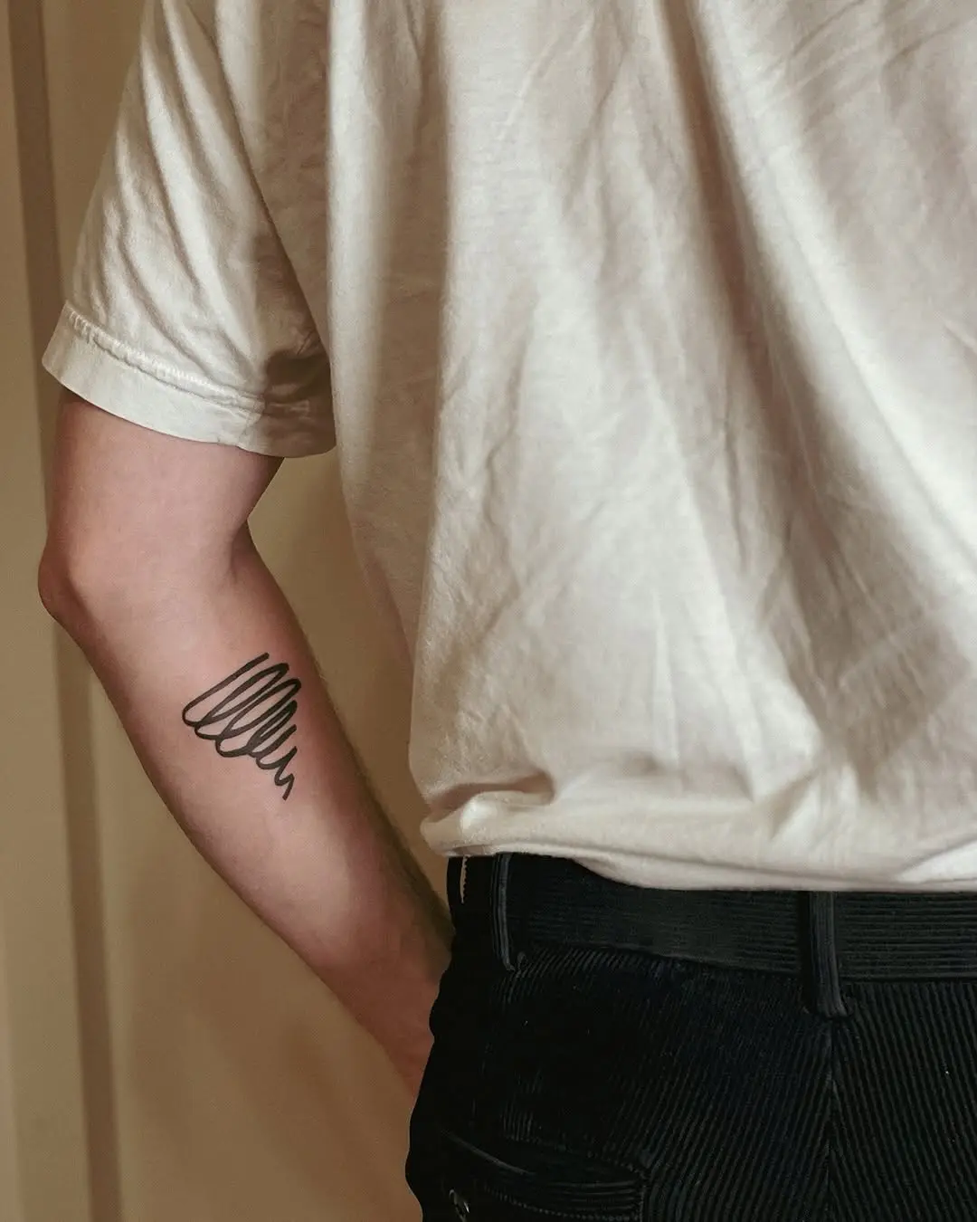 Elegant minimalist jazz-inspired tattoo on arm