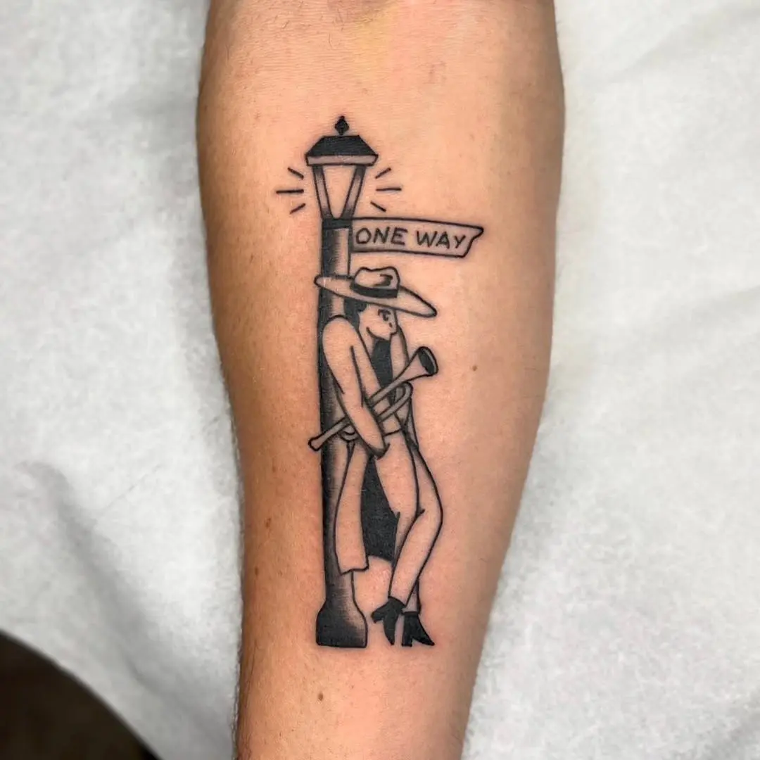 Unique jazz player tattoo with street sign inspiration