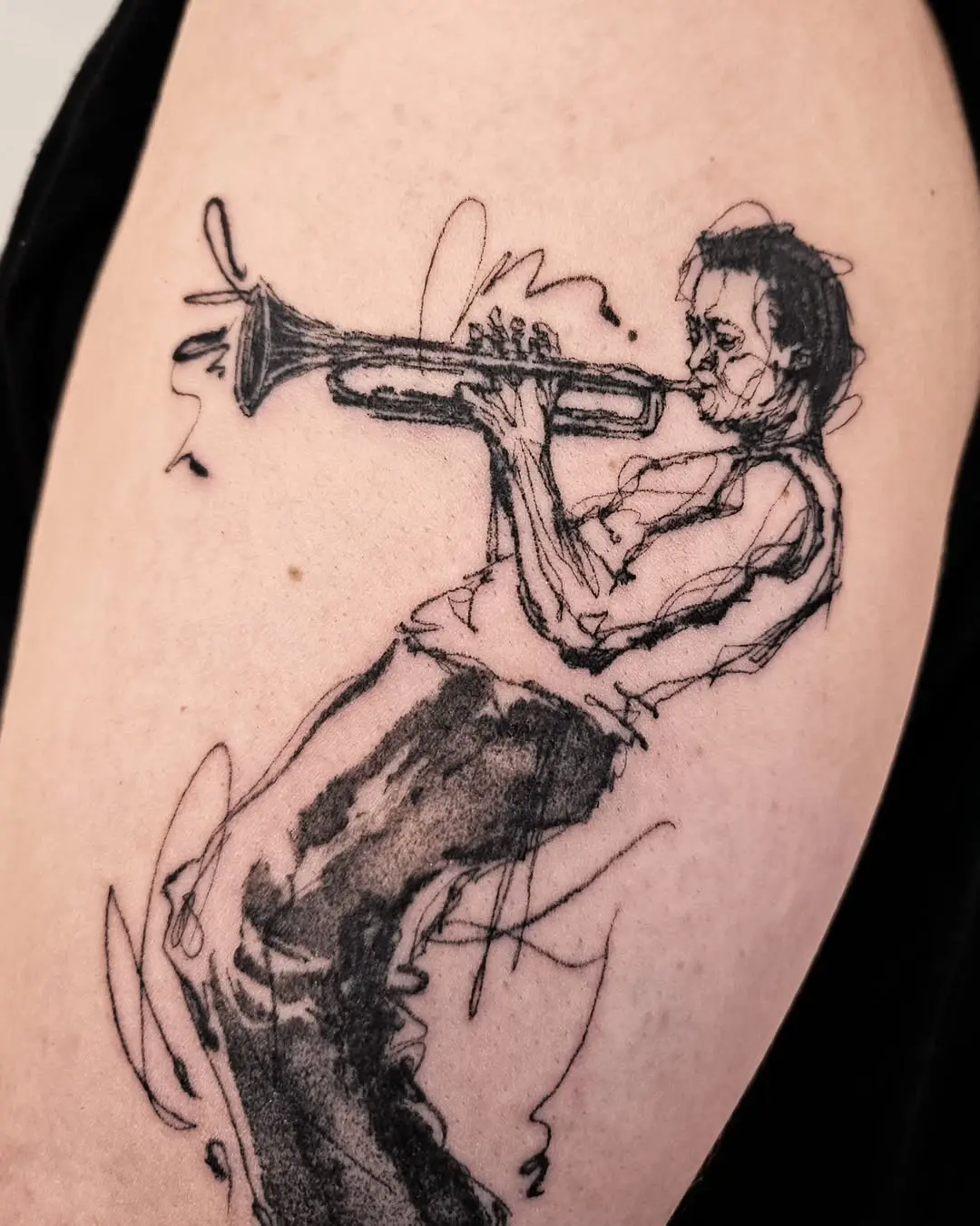 Stylized jazz musician playing trumpet tattoo