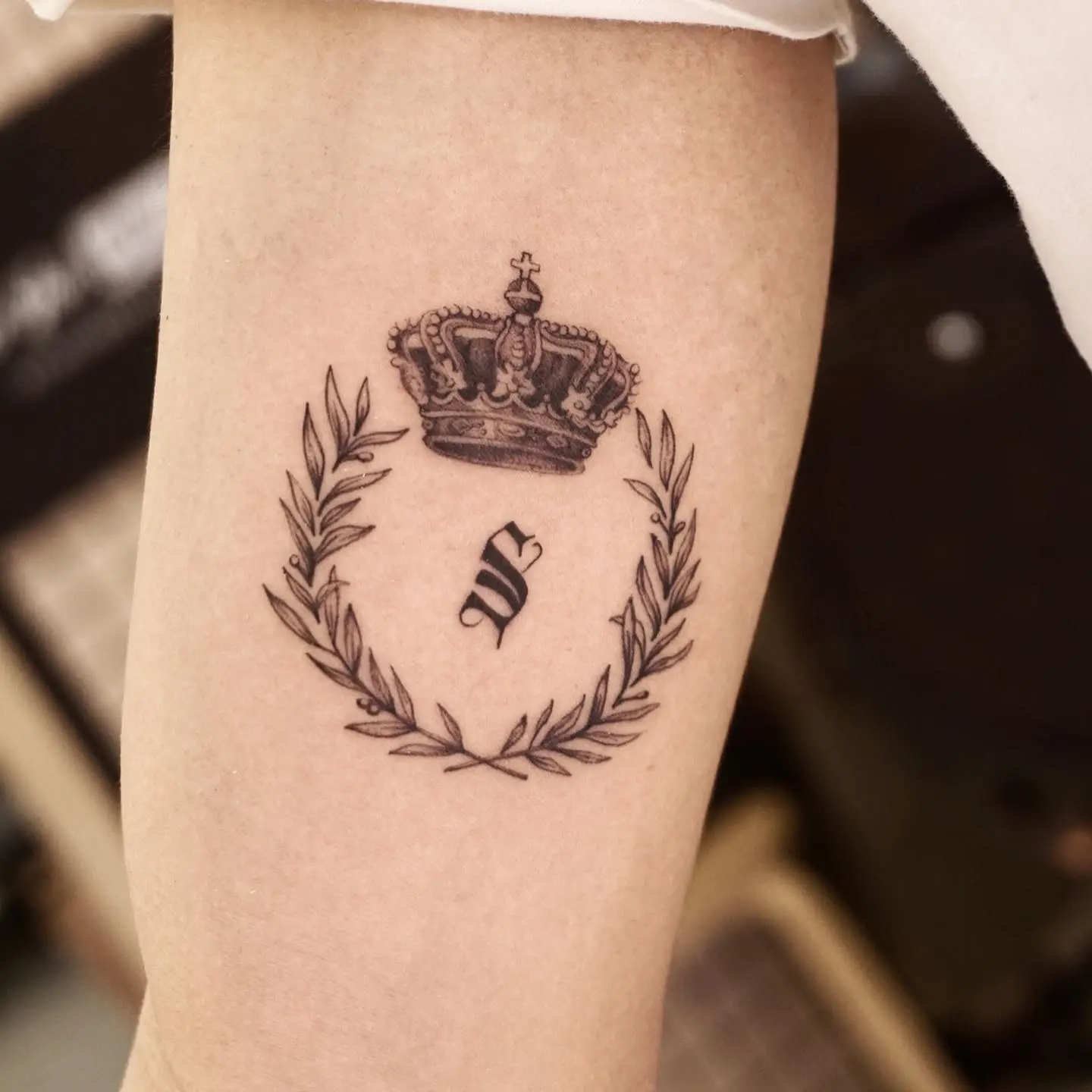 Stylish laurel wreath tattoo with crown detail