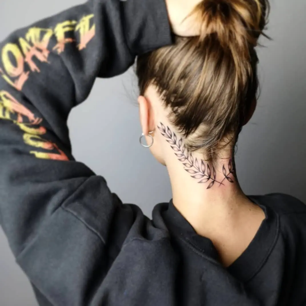 Elegant laurel wreath tattoo adorning the neck