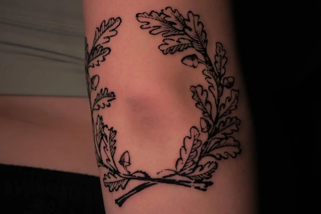 Elegant laurel wreath arm tattoo design