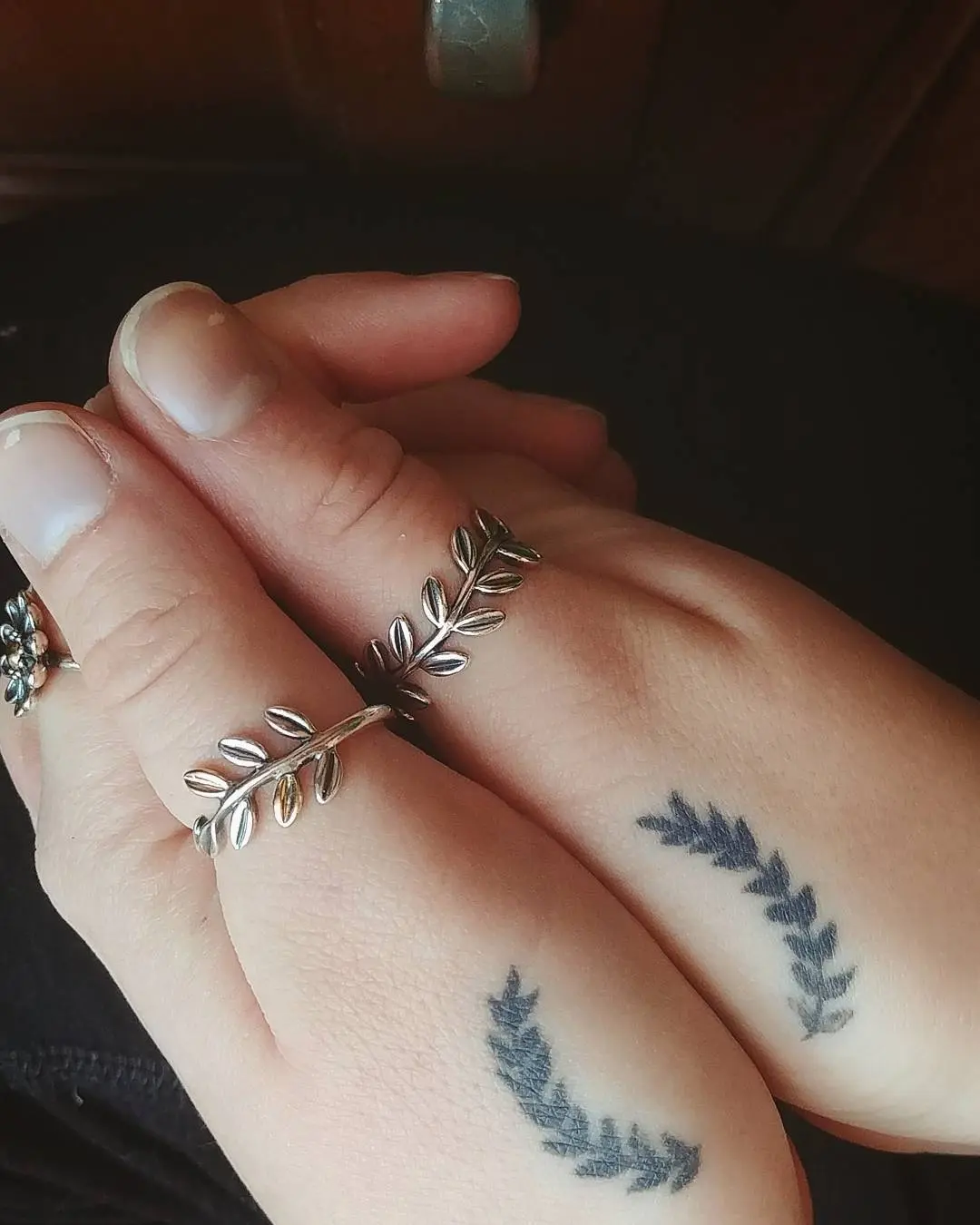 Elegant laurel wreath tattoos on hands