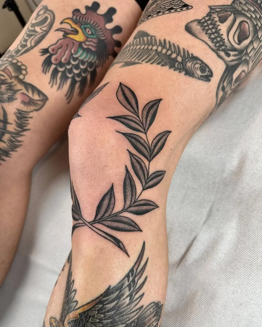 Elegant laurel wreath tattoo on the elbow