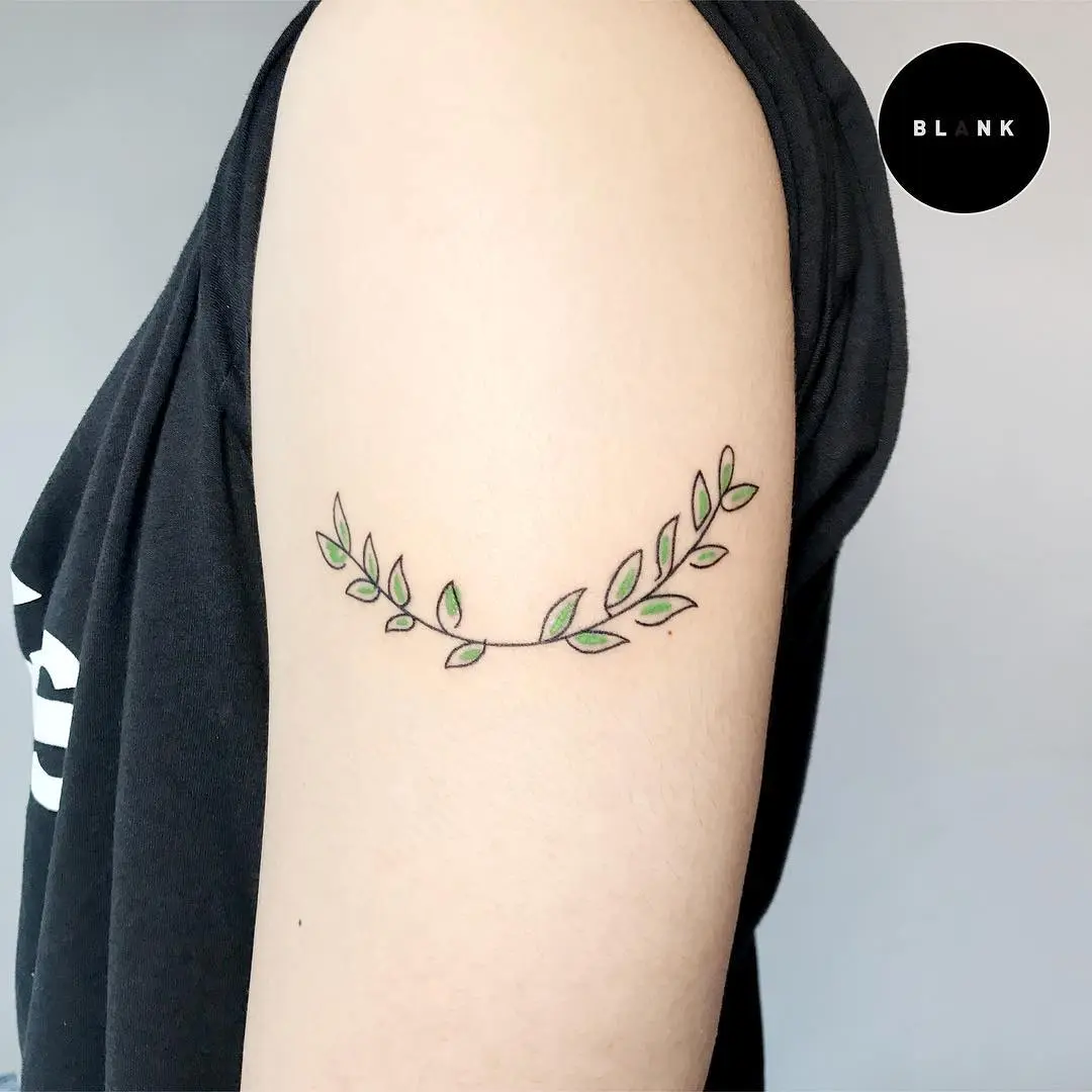 Elegant laurel wreath tattoo with green accents