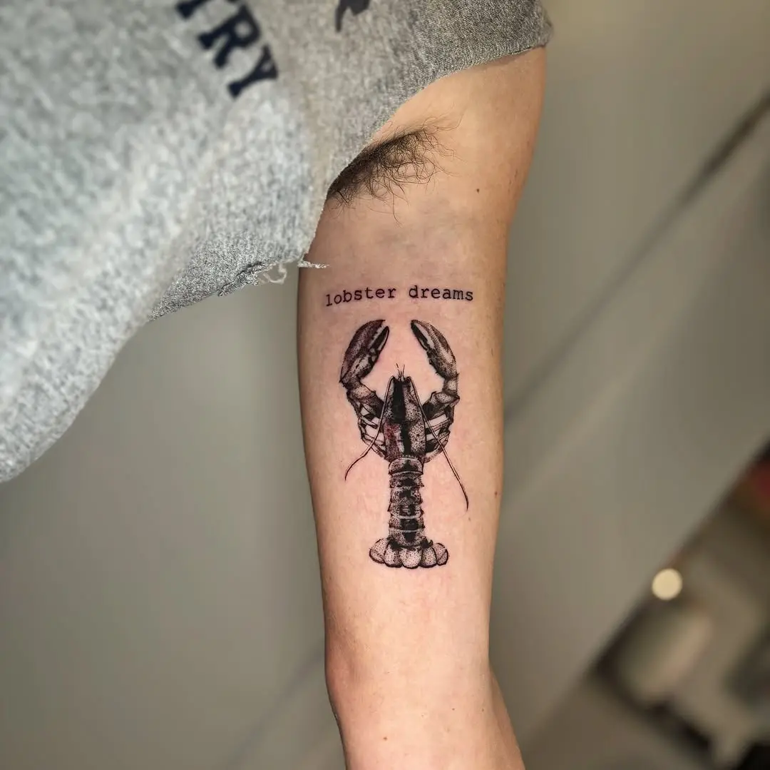 Artistic lobster tattoo with unique inscription