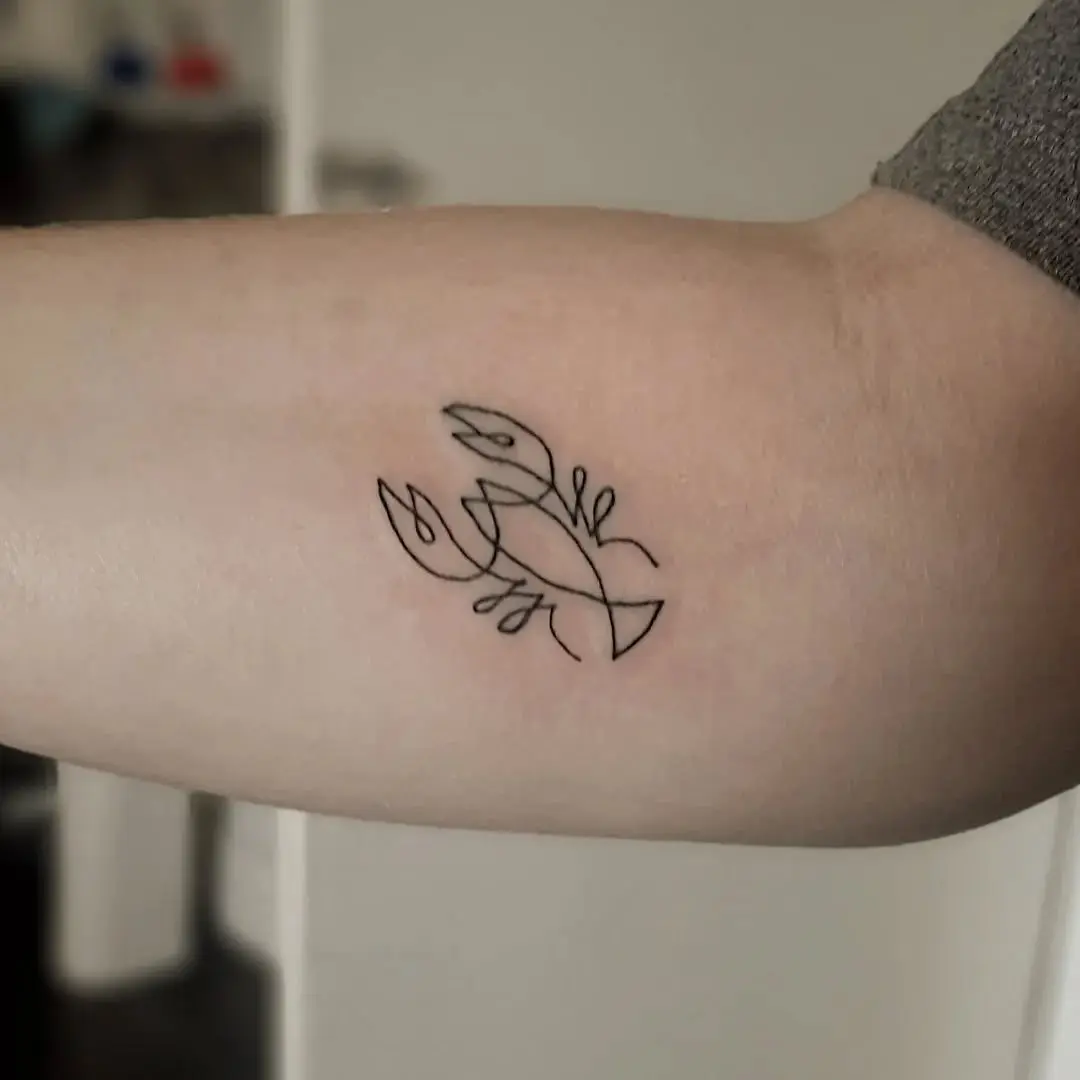Stylish minimalist lobster tattoo on forearm.