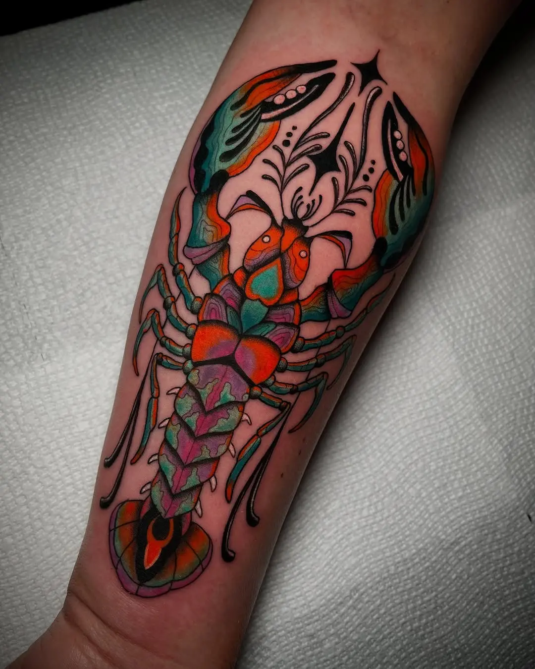 Vibrant lobster tattoo with intricate details