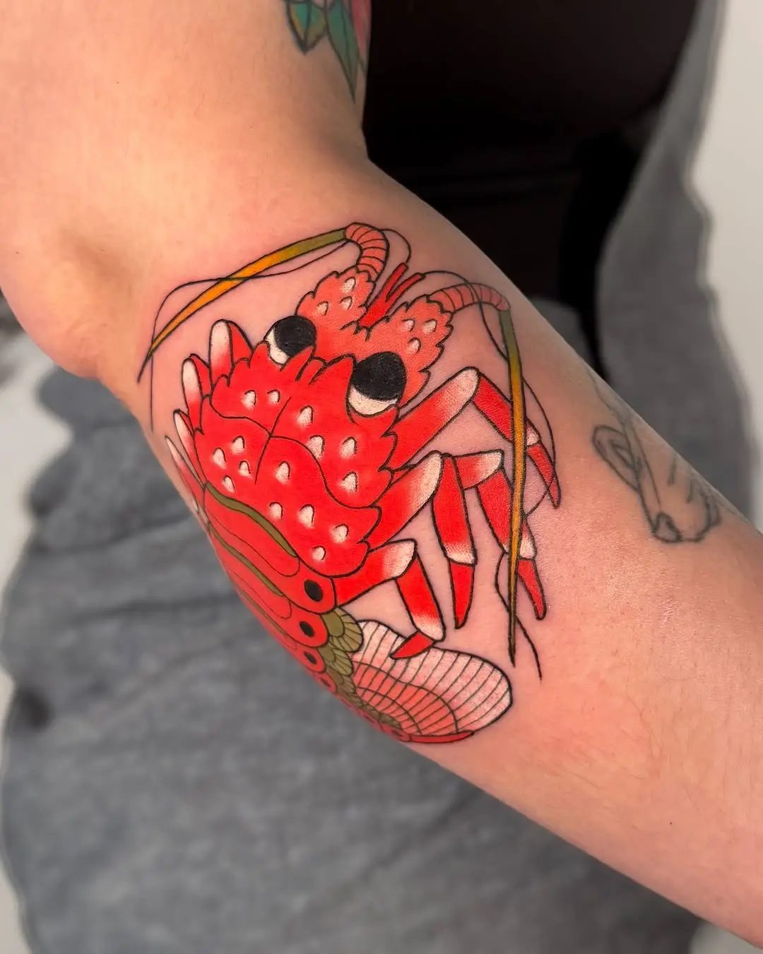 Bold lobster tattoo showcasing vivid red colors