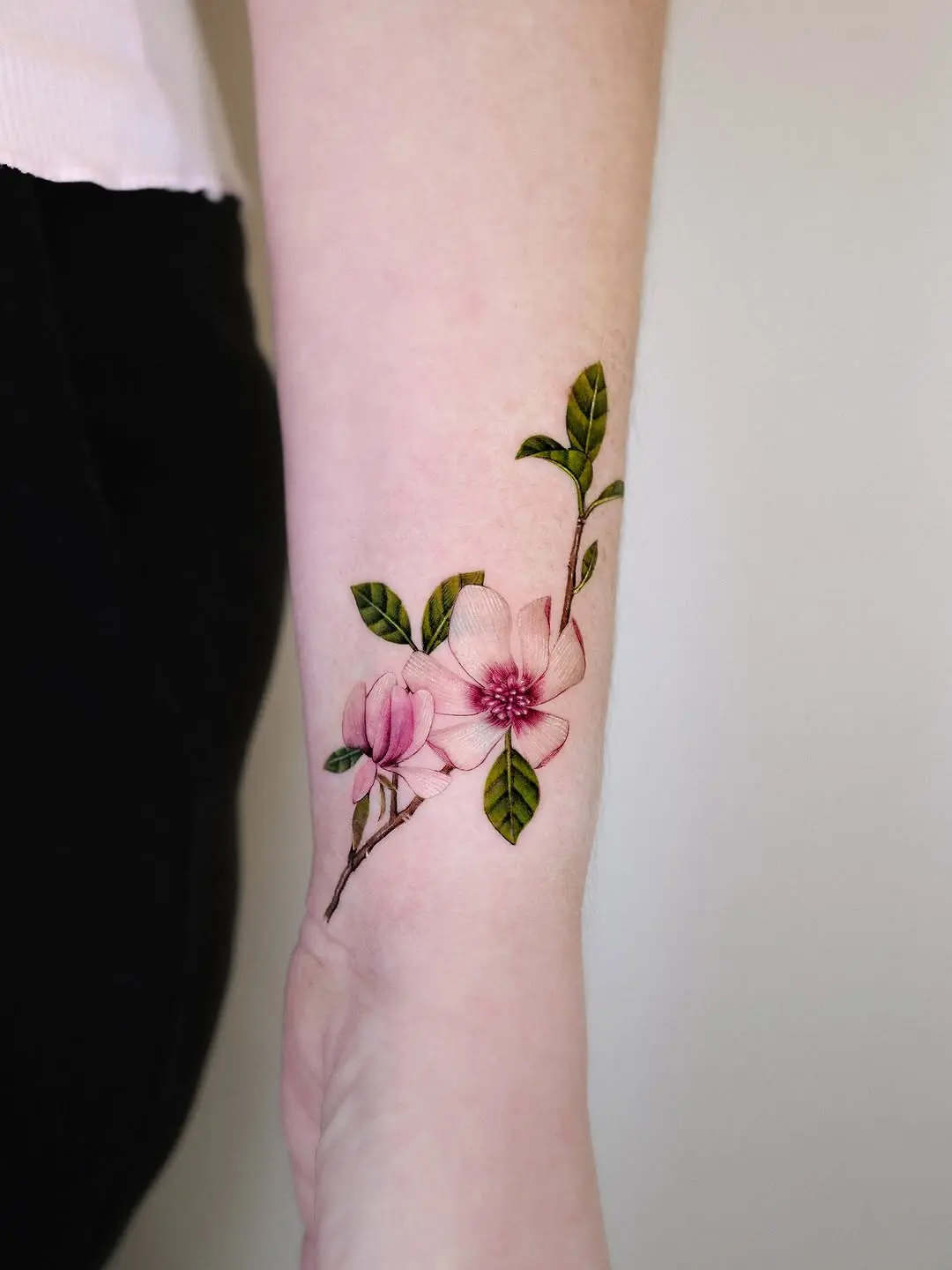 Delicate magnolia tattoo showcasing floral beauty