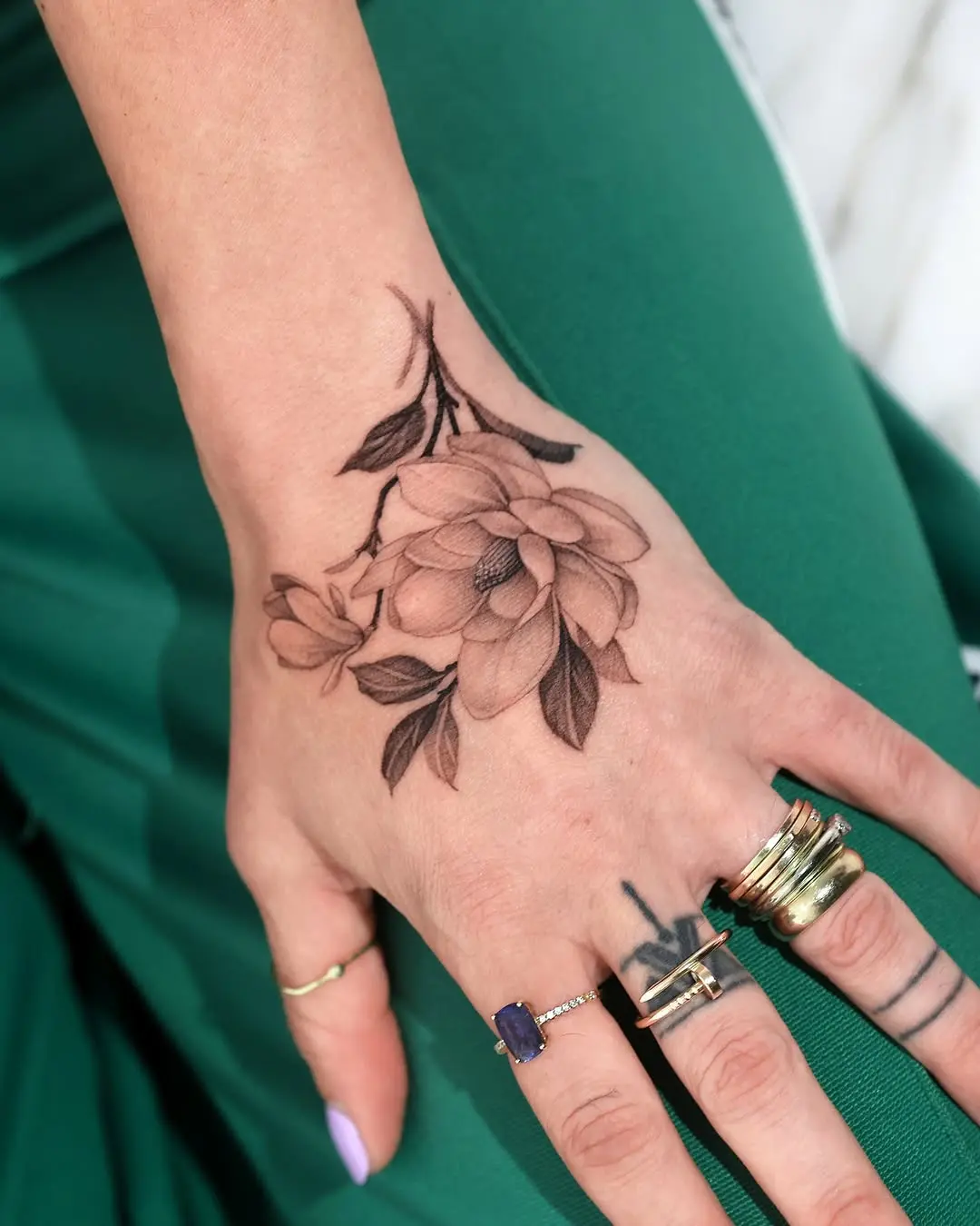 Elegant magnolia tattoo adorning the hand
