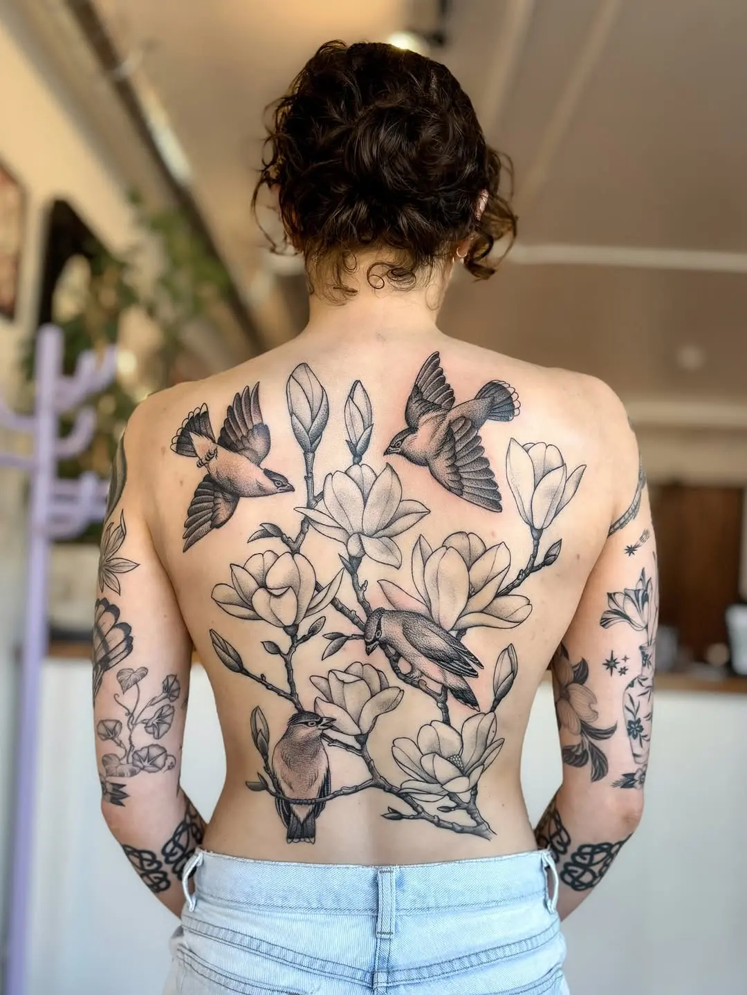 Stunning back tattoo with flora and fauna