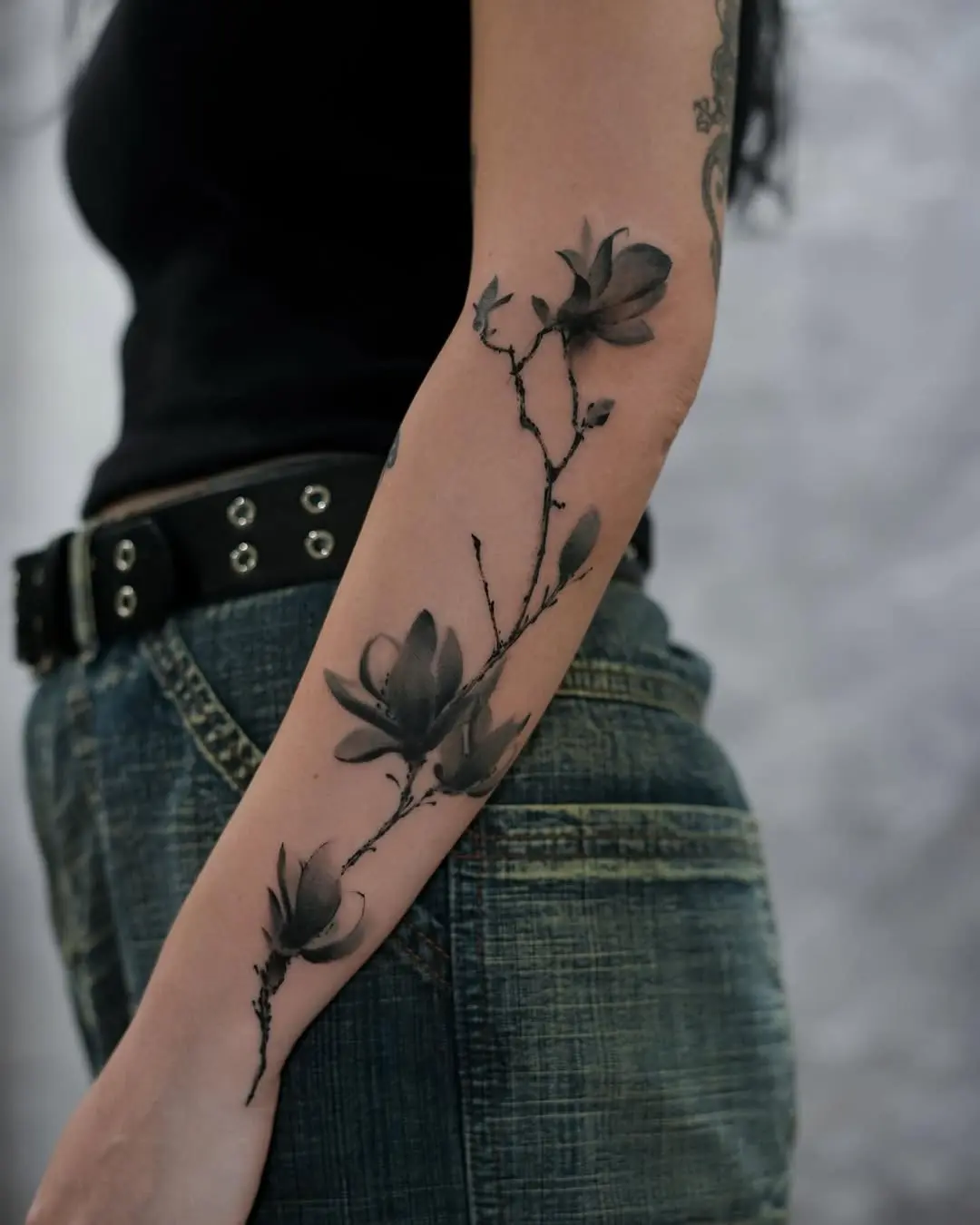 Elegant magnolia tattoo on the forearm