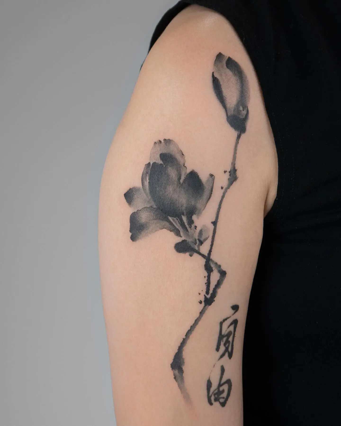 Elegant monochrome magnolia tattoo illustration