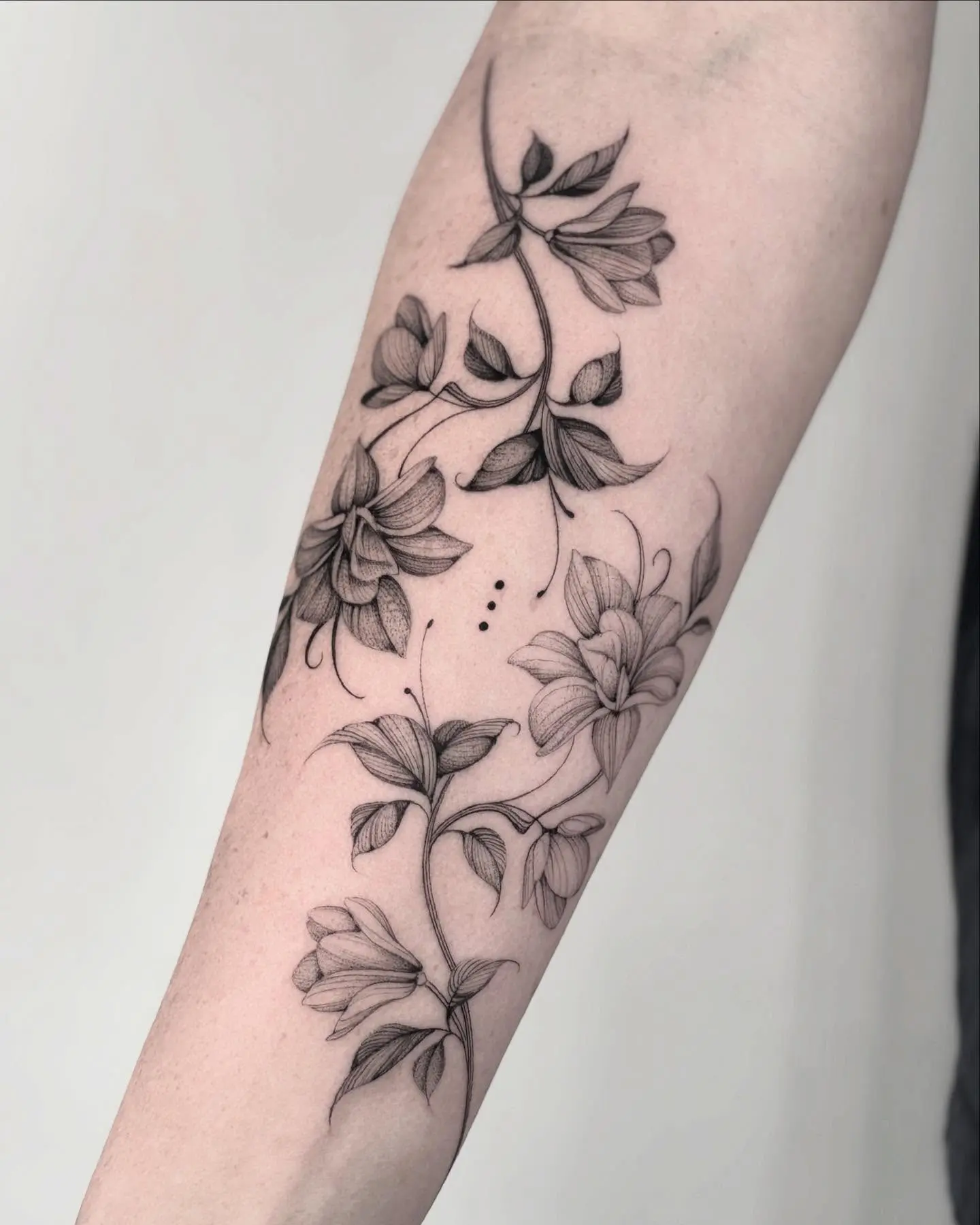 Intricate black and white magnolia tattoo design