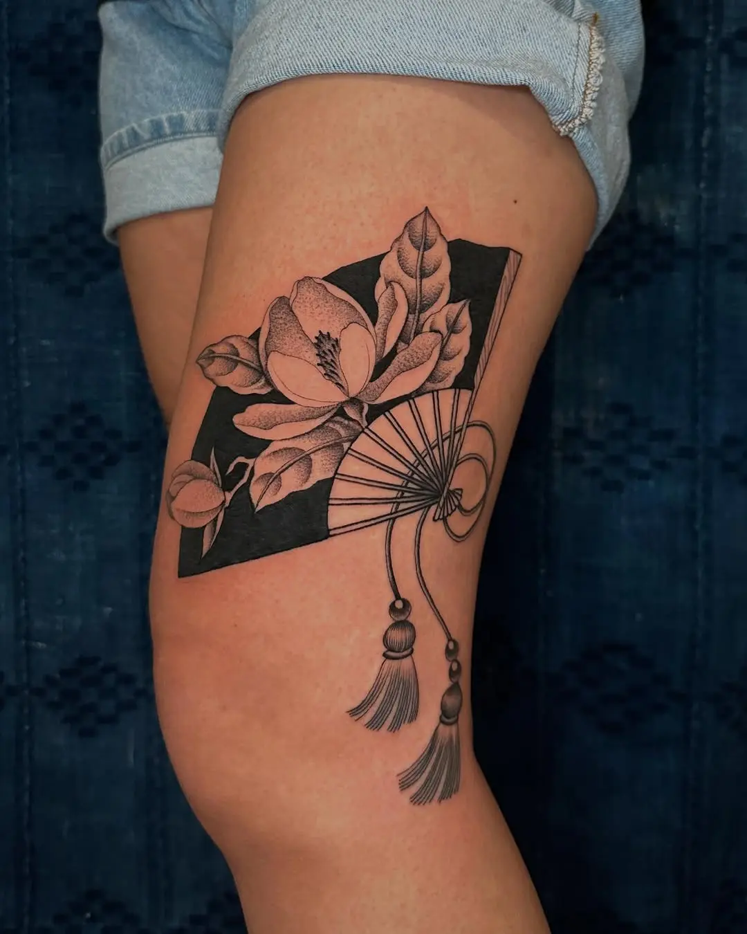 Elegant magnolia tattoo with fan motif