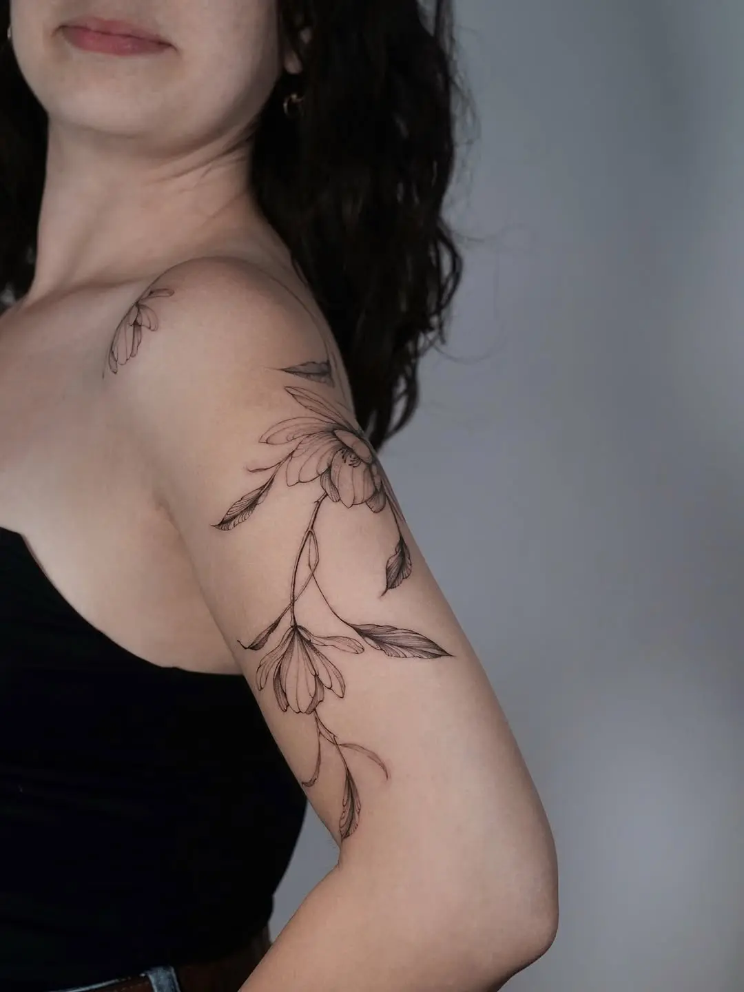 Elegant magnolia tattoo on feminine arm.