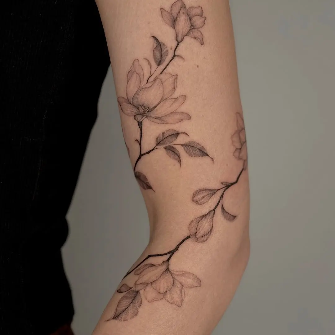 Elegant floral design wraps around the elbow