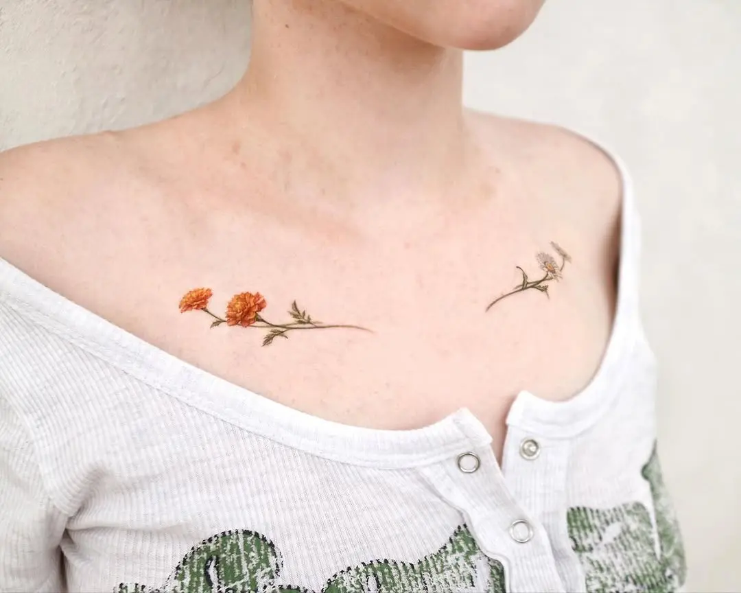 Delicate marigold tattoos gracefully adorn shoulders