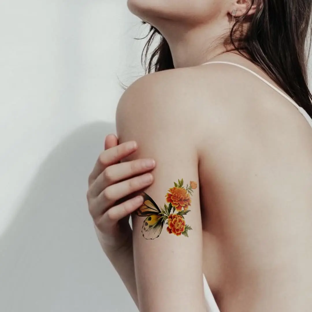 Stunning marigold tattoo with butterfly accent
