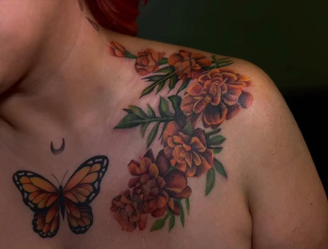 Vibrant marigold tattoo with butterfly detail