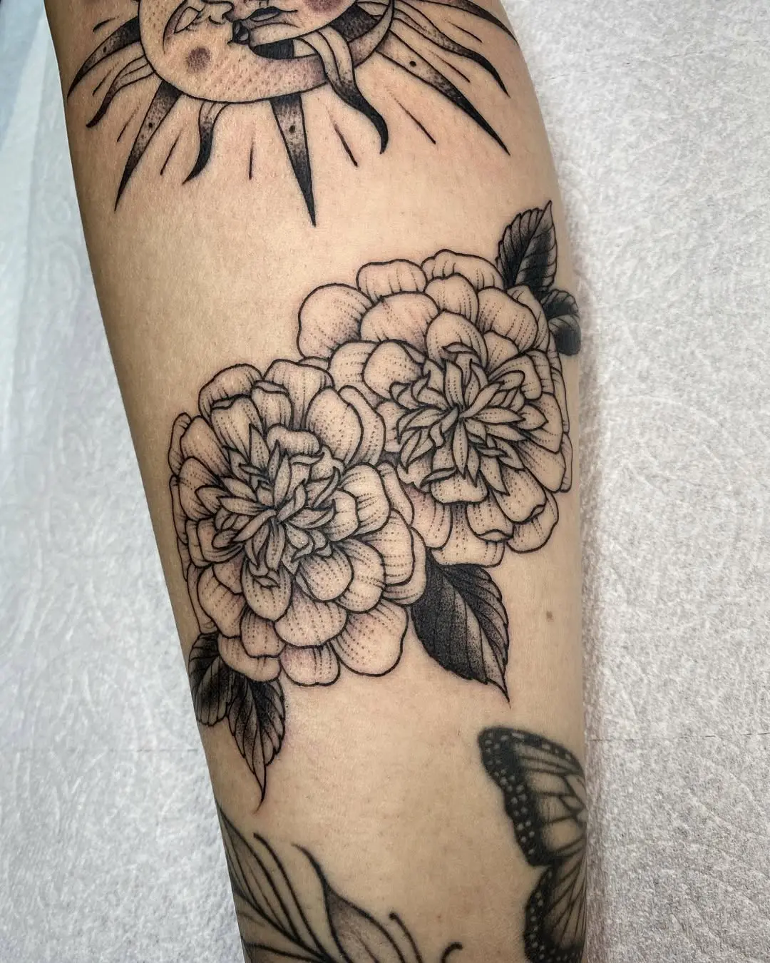 Elegant marigold tattoo with intricate detailing