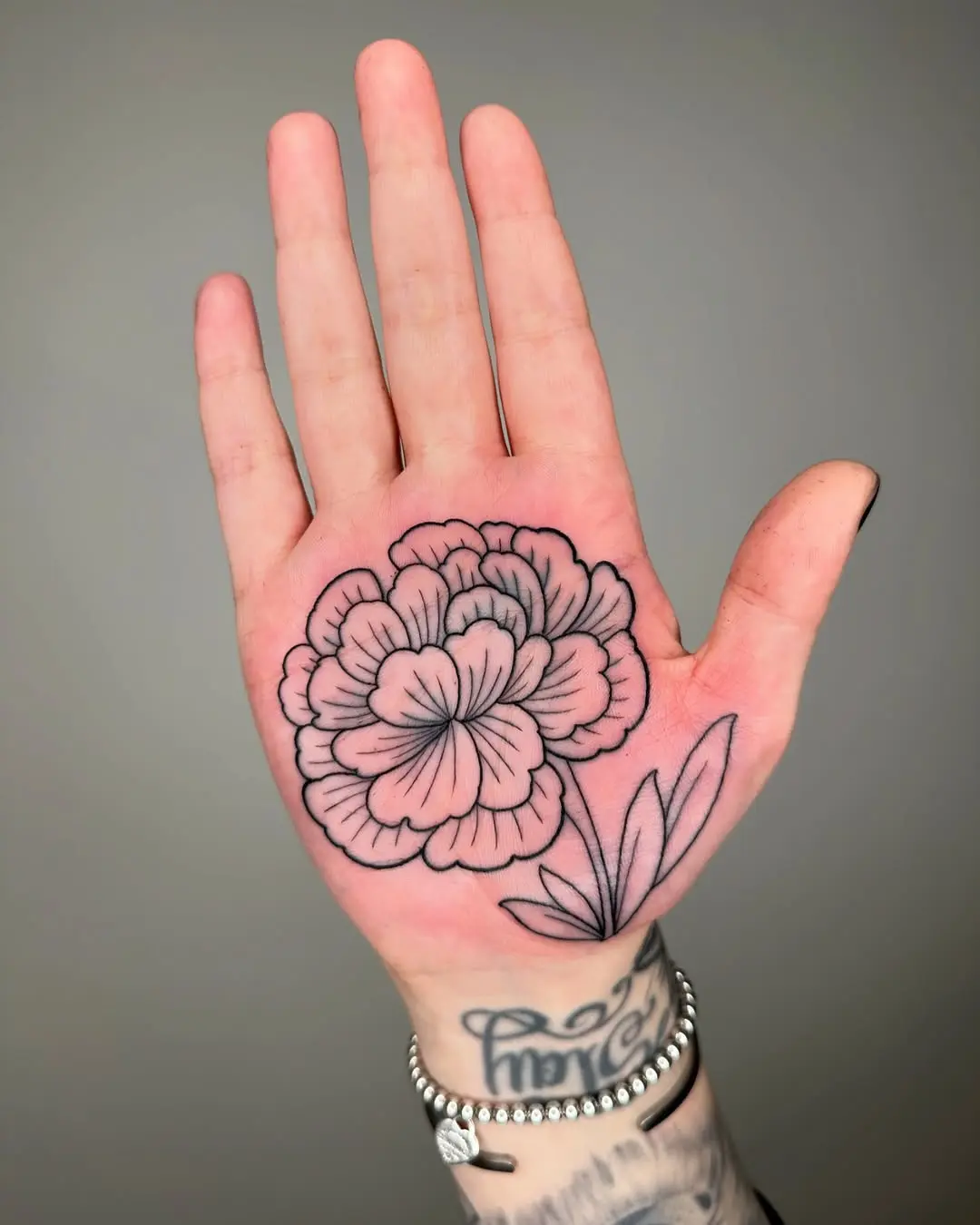 Elegant marigold tattoo on a palm design