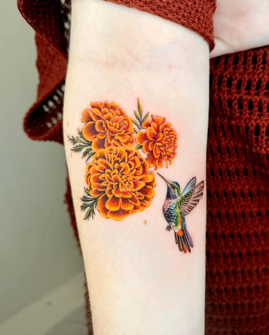 Stunning marigold tattoo with hummingbird
