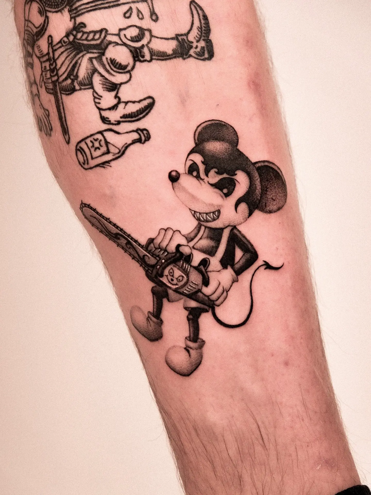Mickey Mouse with a chainsaw tattoo