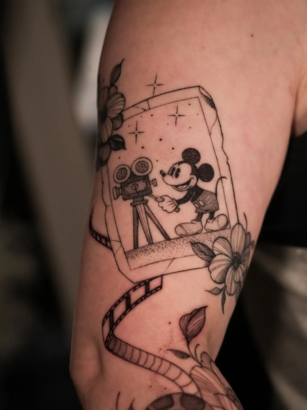 Cheerful Mickey Mouse with vintage camera tattoo