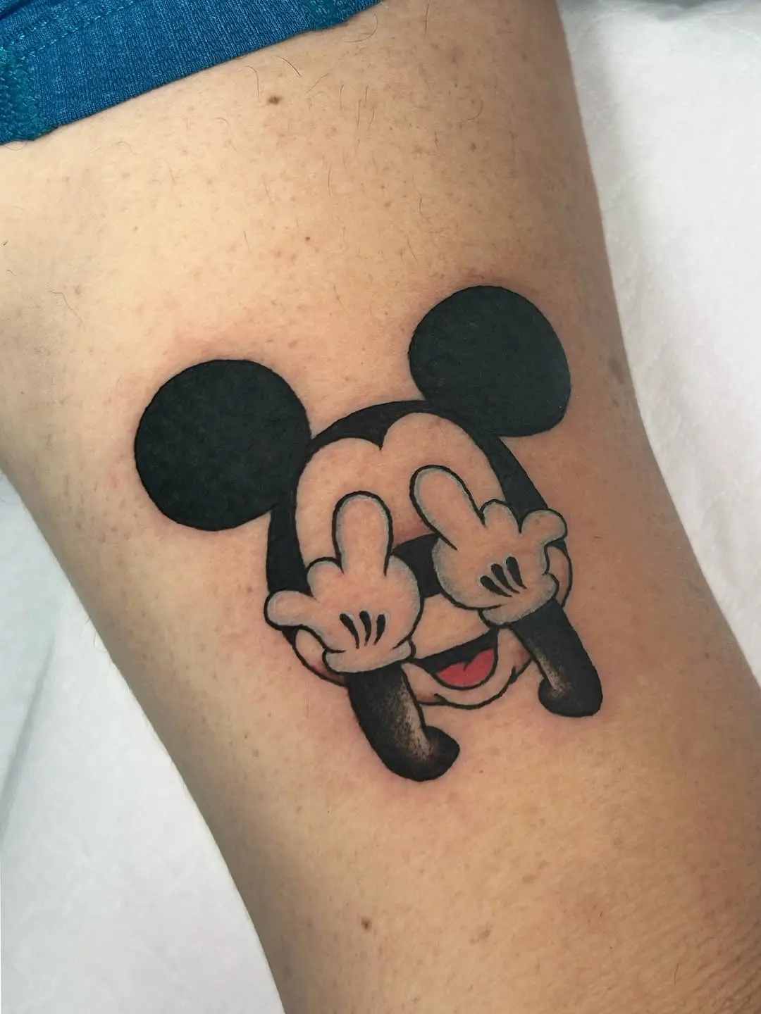Playful Mickey Mouse tattoo with attitude