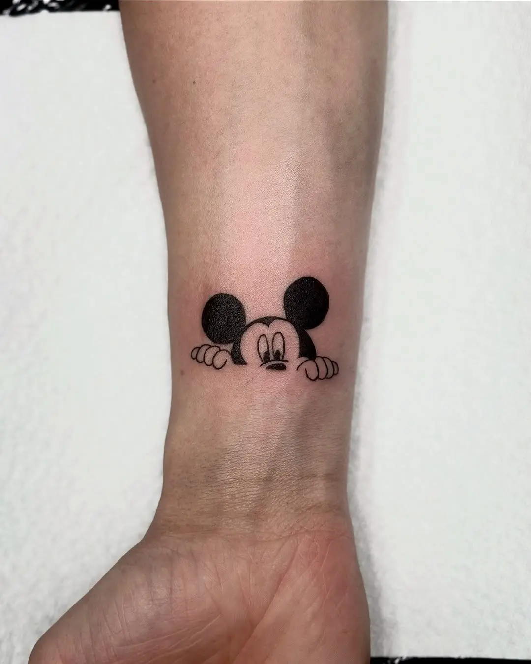 Charming Mickey Mouse Peeking Wrist Tattoo