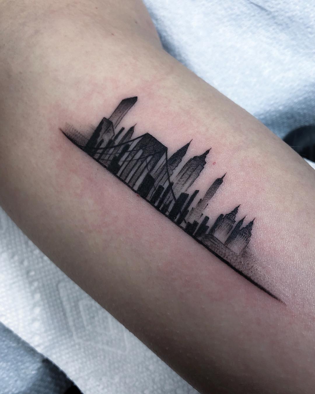 Elegant skyline tattoo with minimalist design